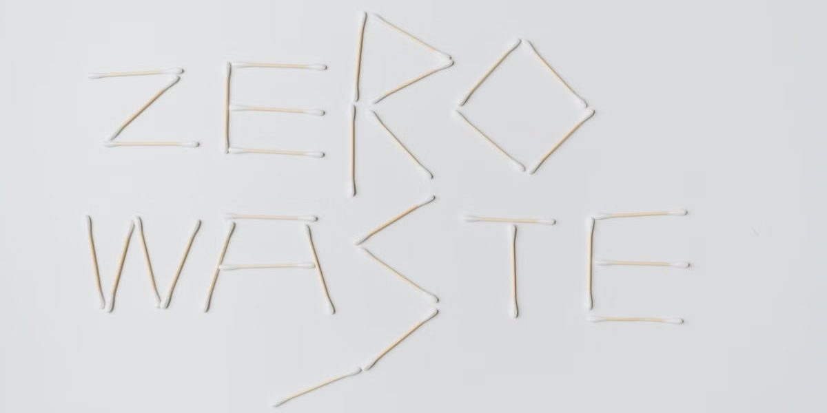 Creative layout of zero waste sign formed with cotton swabs on a white background.