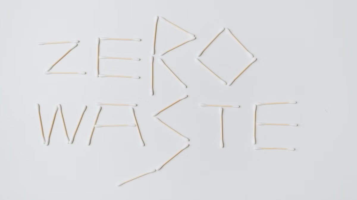 Creative layout of zero waste sign formed with cotton swabs on a white background.